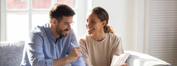 Two young adults reviewing mortgage documents